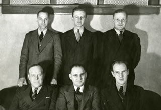 A black and white image of a group of unidentified Hamline men wearing suits and ties