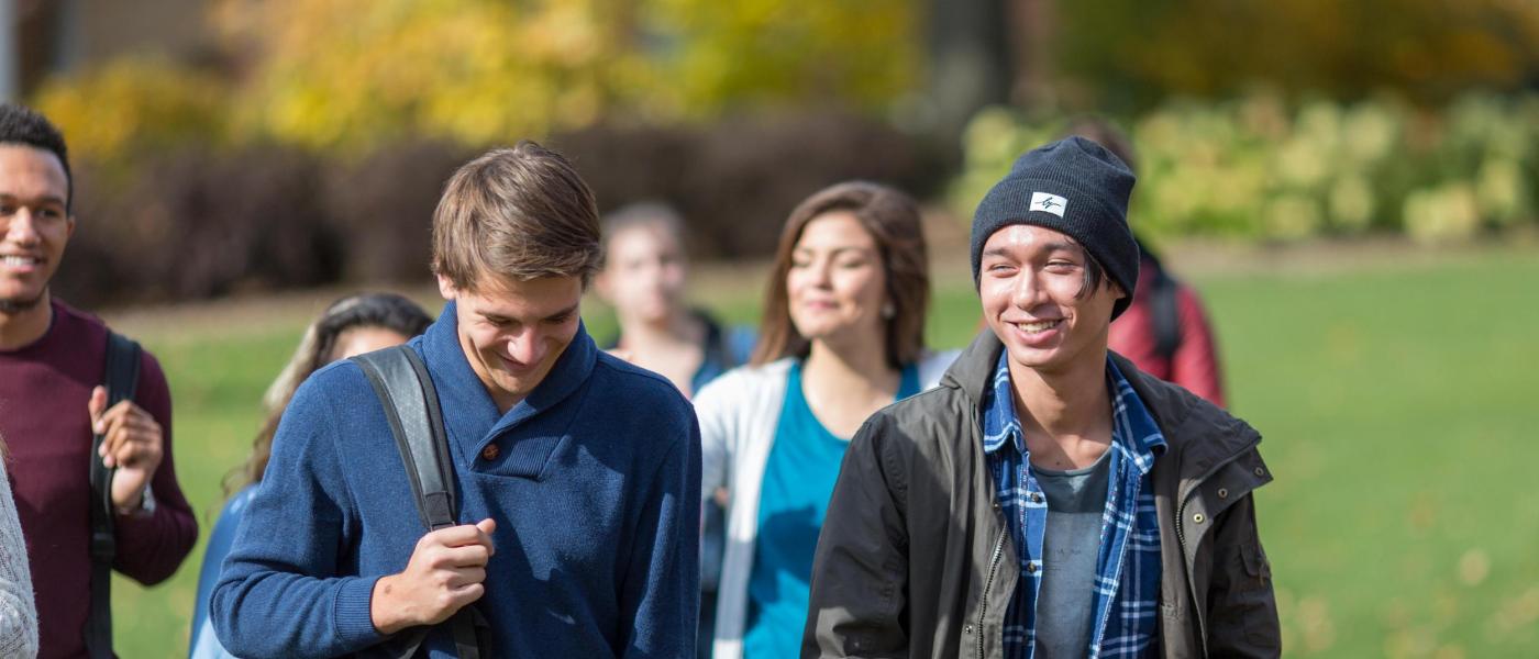 Student walking on campus in group