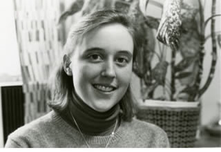 A black and white photo of an unidentified smiling female Hamline student from the archives