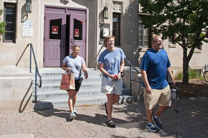 Parents and a student walk outside of Drew Residence Hall