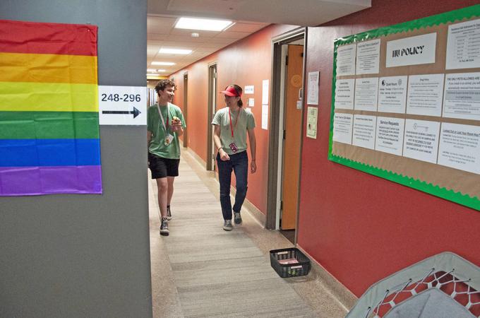 Two students walk through the hallway of Drew Residence Hall