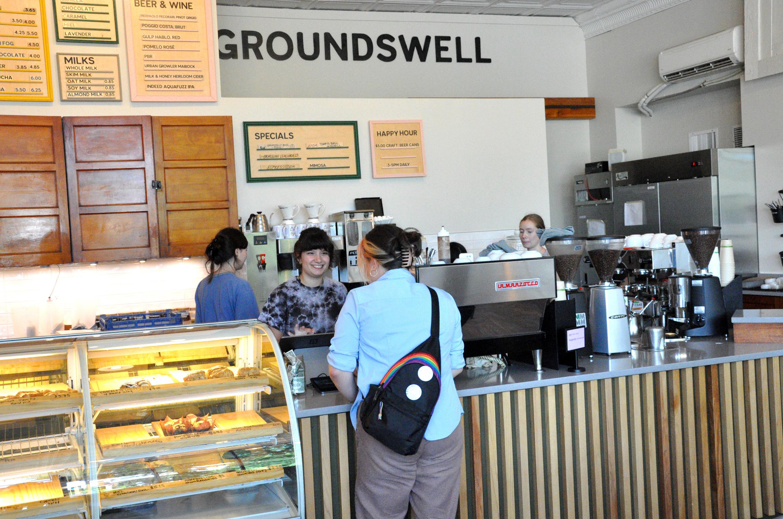Student standing at the front counter of Groundswell