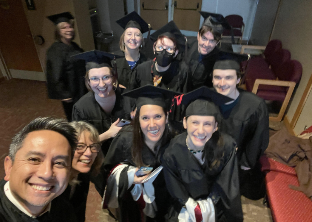Minh Le, faculty of Hamline's MFA in Writing for Children and Young Adults (MFAC) program, with MFAC students on graduation day 