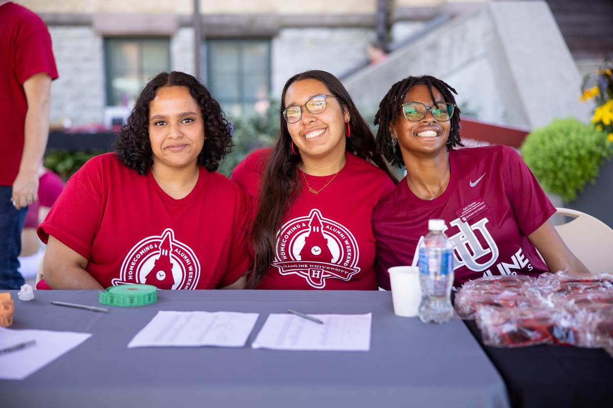 Three Hamline student congress (HUSC) members at a table