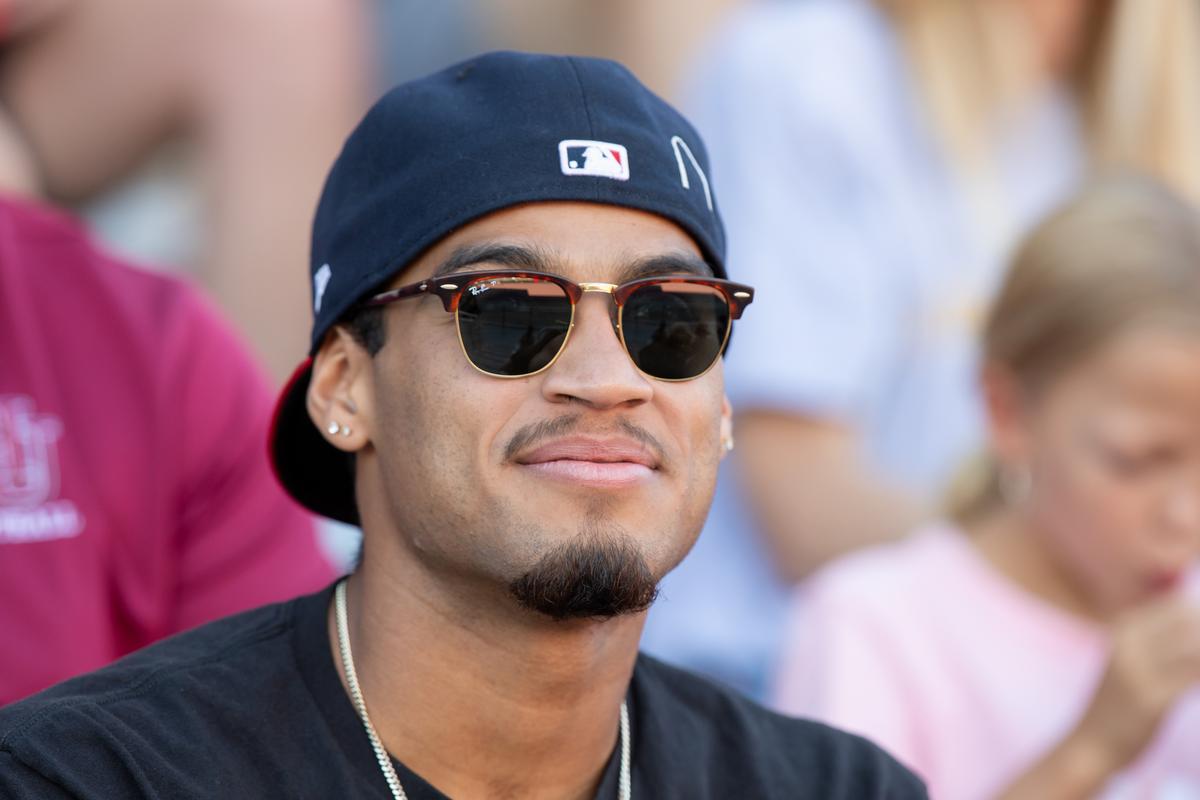A Hamline student watching a game in a stadium