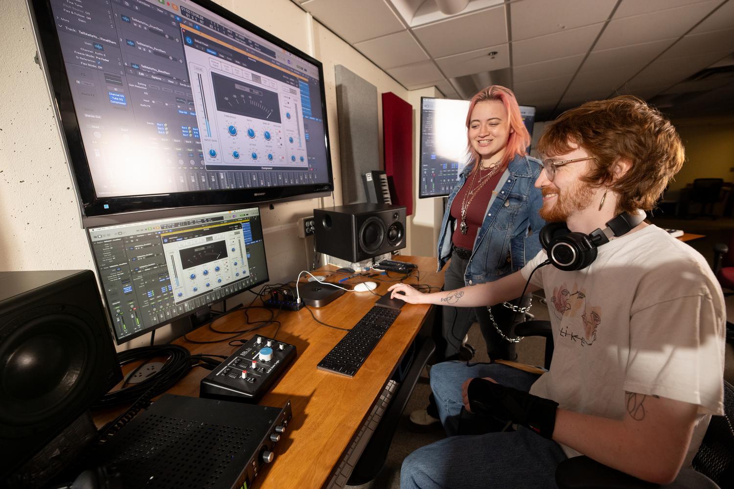 H. Jones and Thomas Neuger using software in the music production studio