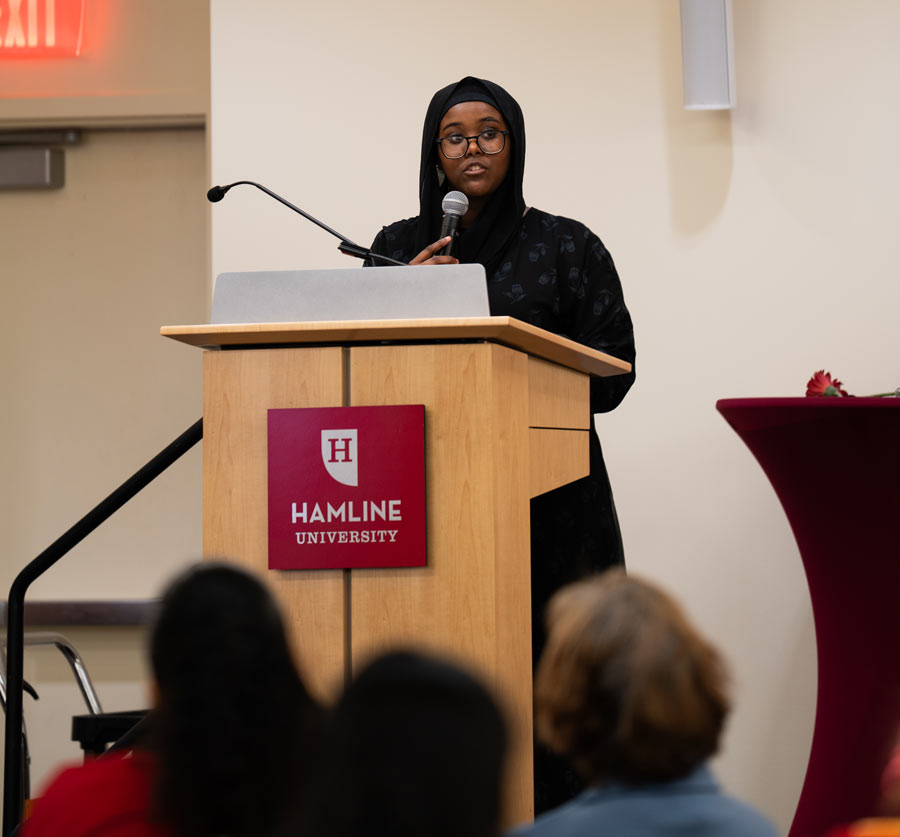 First-generation student at podium