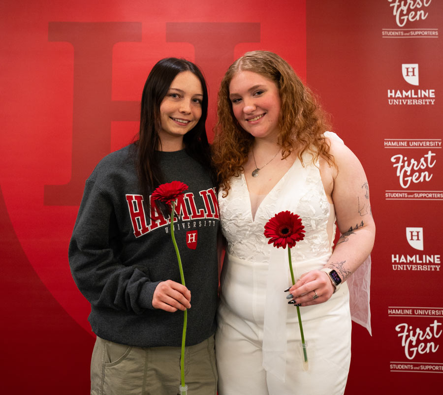 Two first-gen seniors with roses