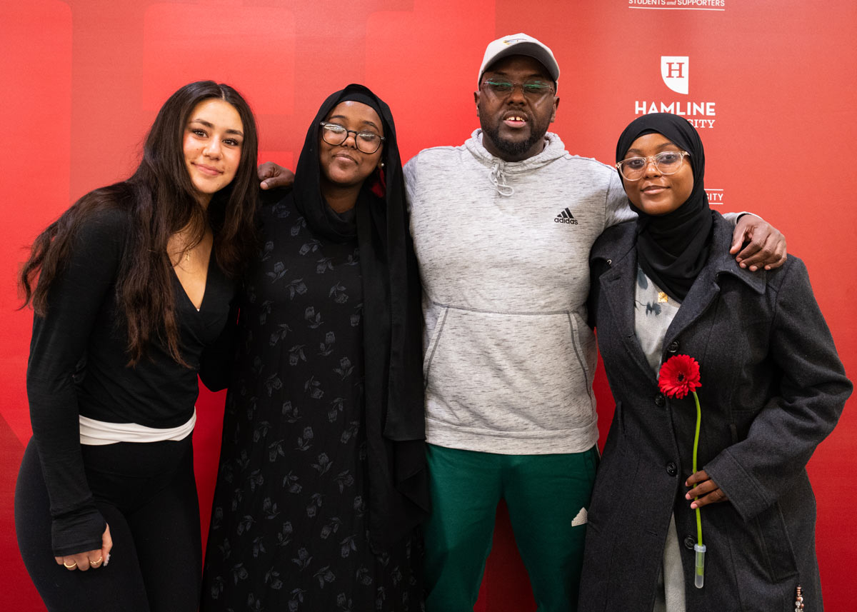 Four first-gen seniors posing at pinning ceremony