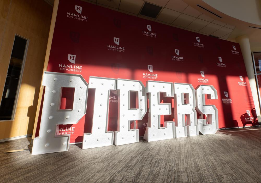 Large "Pipers" sign in East Hall for Homecoming and Alumni Week