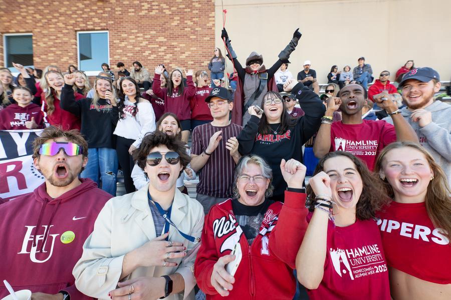 Crowd of students cheering, with Piper in background, during Homecoming and Alumni Week