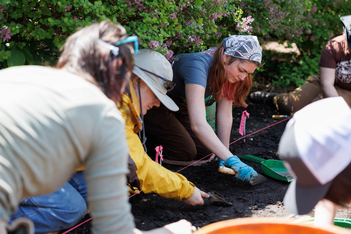 Anthropology students digging in the dirt
