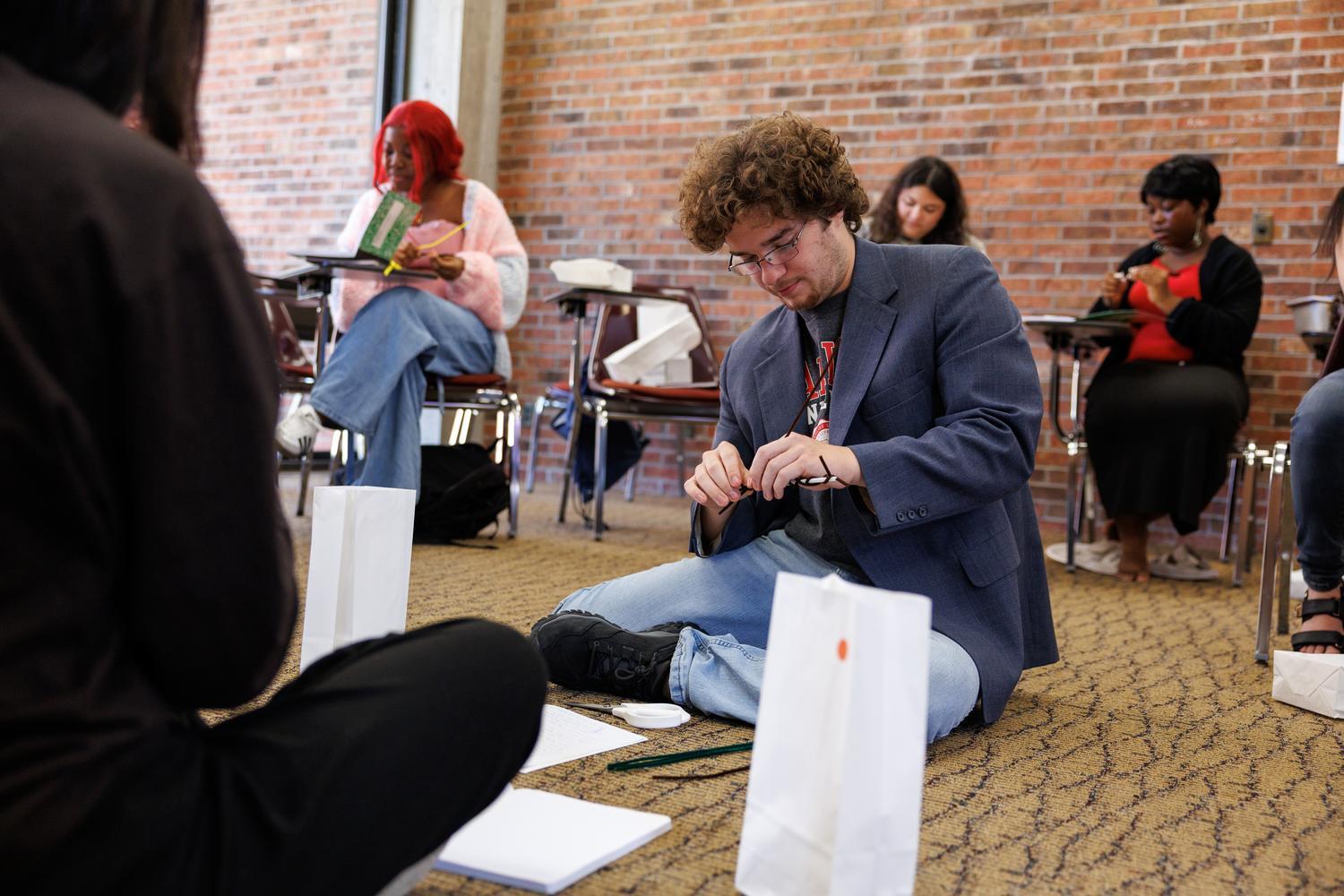 Student doing an activity in a group at a TRiO event
