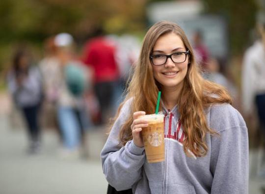 Hamline transfer student Hailey Belflower smiling outside on campus