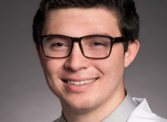 Dr. Johnny Nguyen, smiling at the camera in a white coat