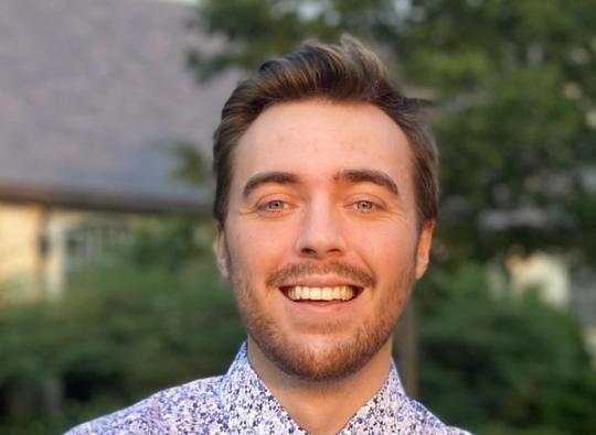 Max Bolger standing outside and smiling