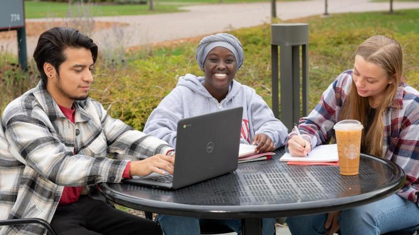 Three students studying outside