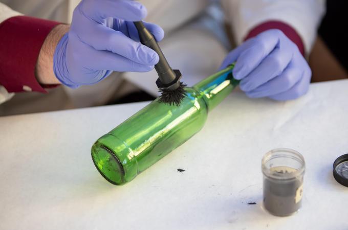 Forensic science major dusting for fingerprints, Hamline University