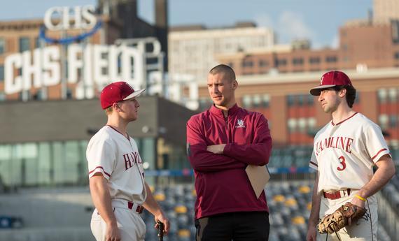Two Hamline Undergraduate Students Athletics with a coach on CHS Field 