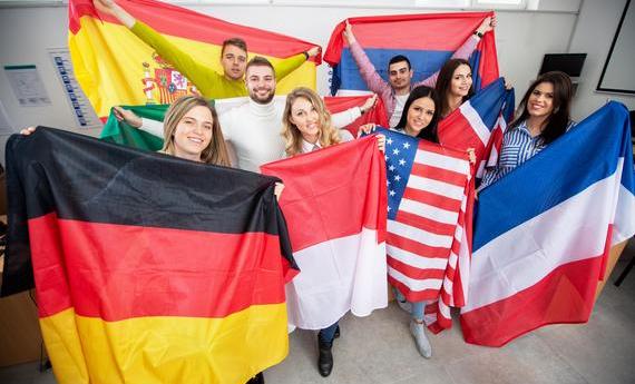 Group of international exchange students holding various country flags
