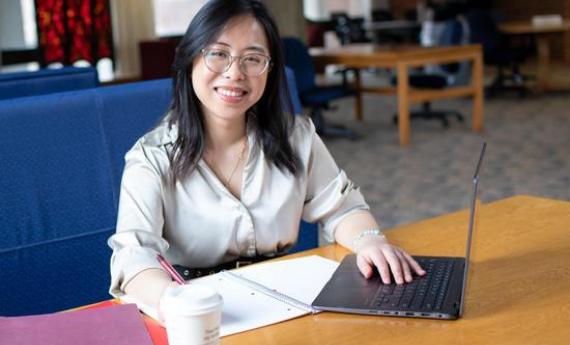 An international undergraduate student at Hamline studying in the library