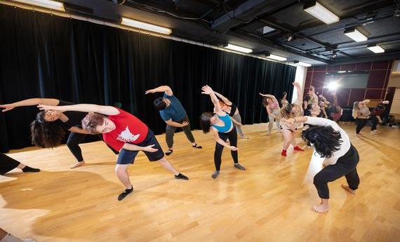 Photo of students stretching in dance studio