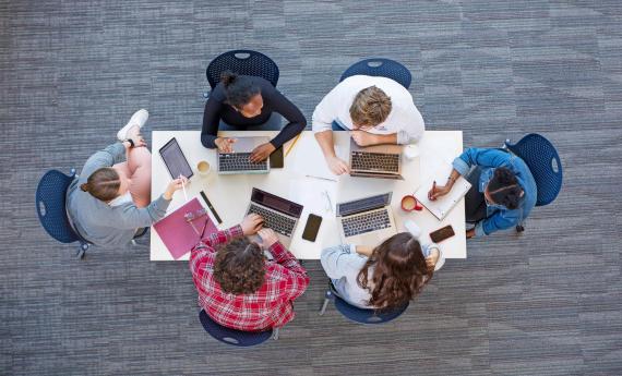 Creative Writing program students, birds-eye view of table and students