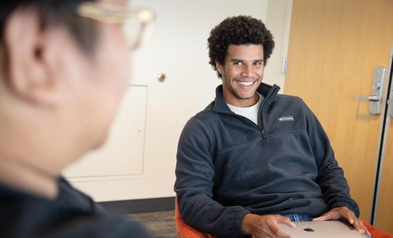 student with computer on lap