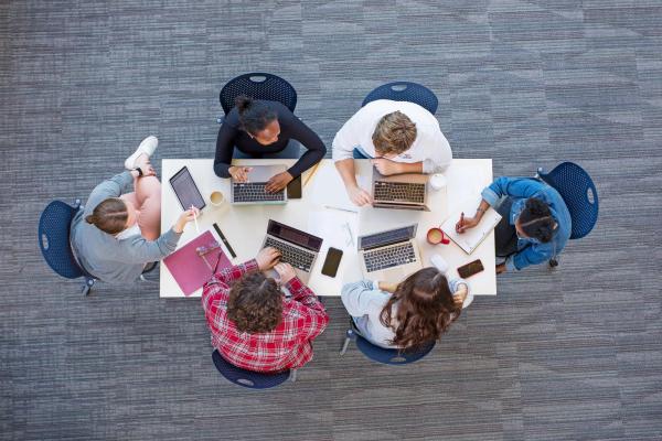 Creative Writing program students, birds-eye view of table and students