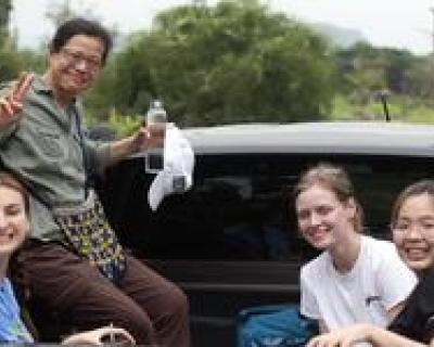 Professor Ishida with Hamline Students in truck on study away trip to Thailand