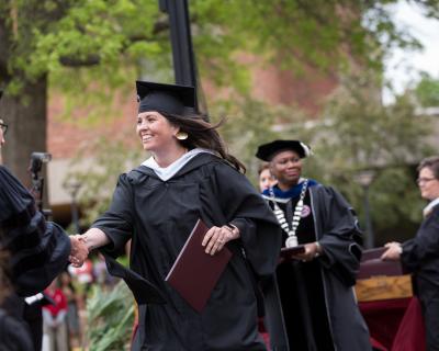 A graduate earns their degree at Commencement.