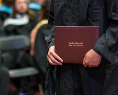 A graduate holds a diploma