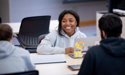 Student with laptop at table