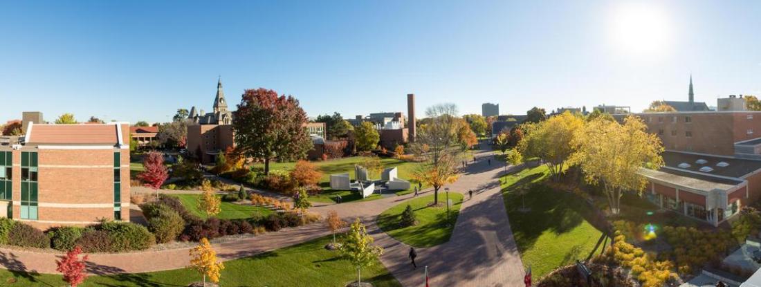 An aerial shot of Hamline University during the fall, with students walking on the sidewalk