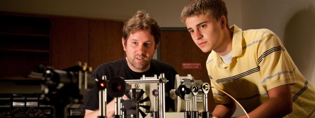 Two people working on an engineering project together at a table