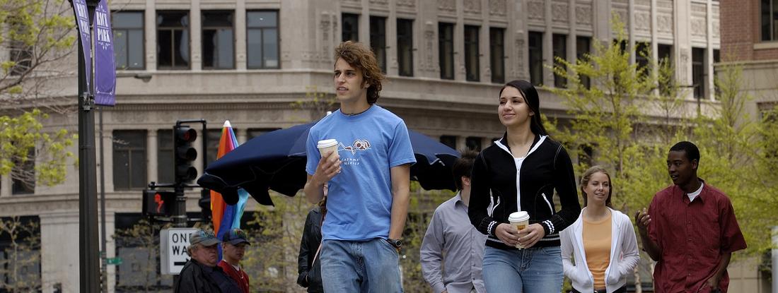 Students holding a coffee around Twin Cities