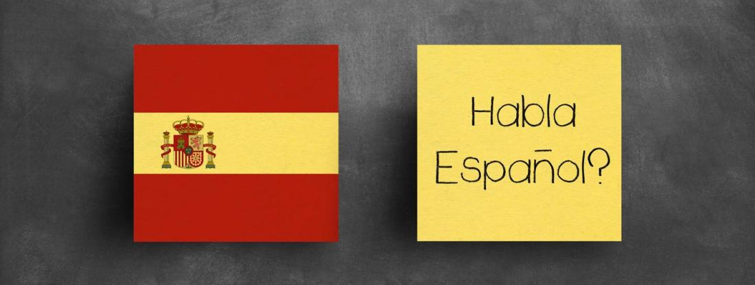 the flag of Spain next to a yellow box that says "Habla Español?"
