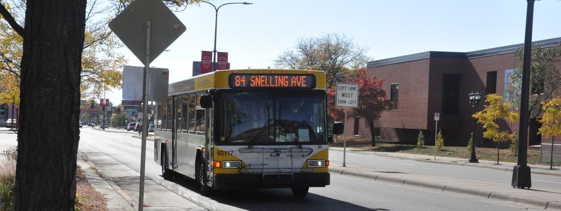 A bus driving in front of Hamline University 