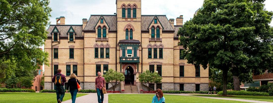 Hamline Old Main view with students walking around the campus