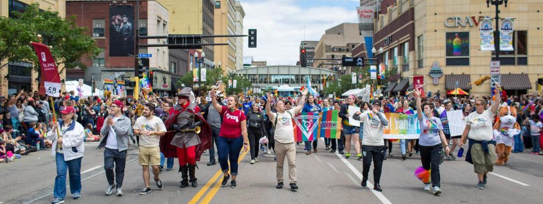 A large group of Hamline community members marching in a pride parade