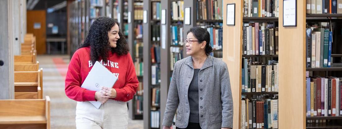 Hamline students and professors talking at Hamline Bush Library