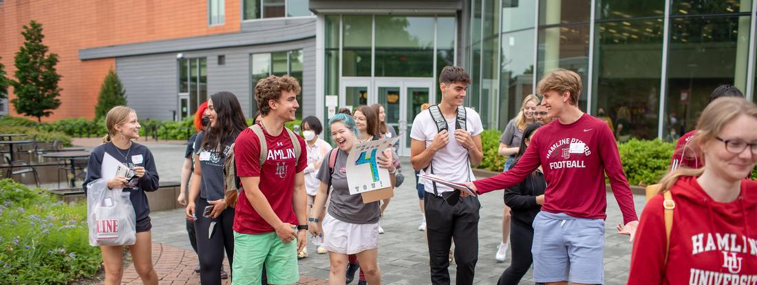Hamline Admitted First Year Students waliking happy in front of Anderson Center
