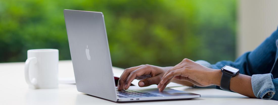 hands on a laptop