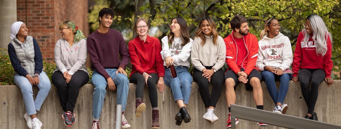 students sitting on wall