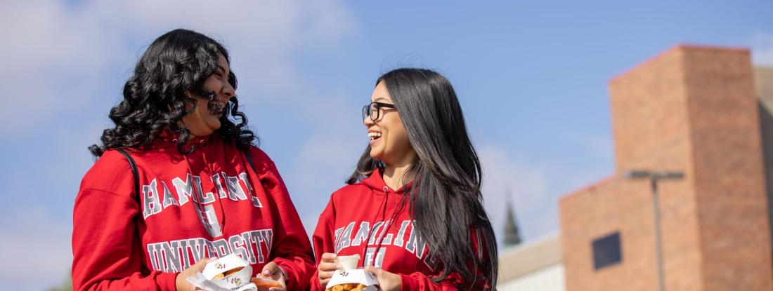 Two students with Hamline sweatshirts