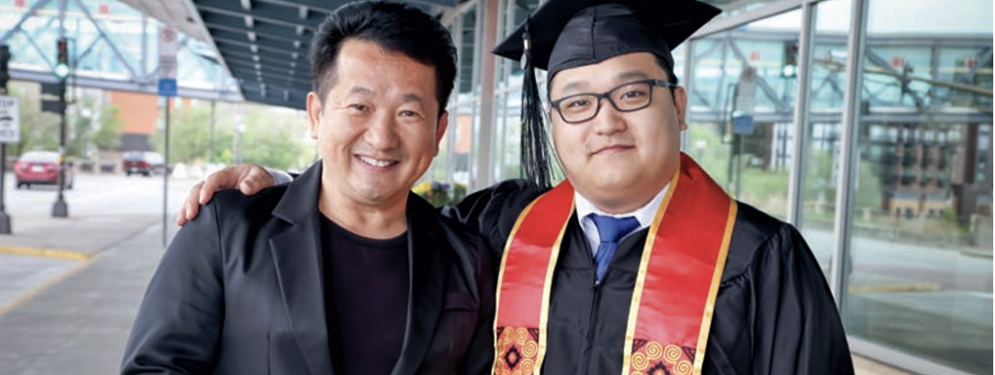 Dr. Xengsul Yangwaue '98 and Tshuaj Yangwaue '25 posing at Commencement