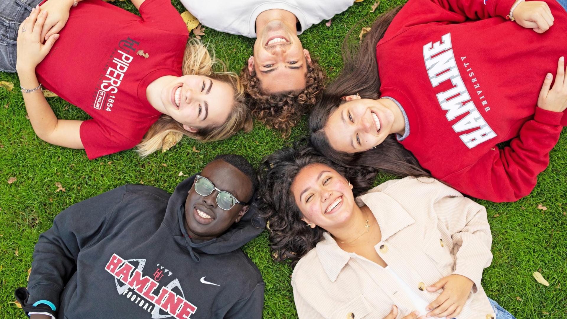 Students with Hamline sweatshirts relaxing