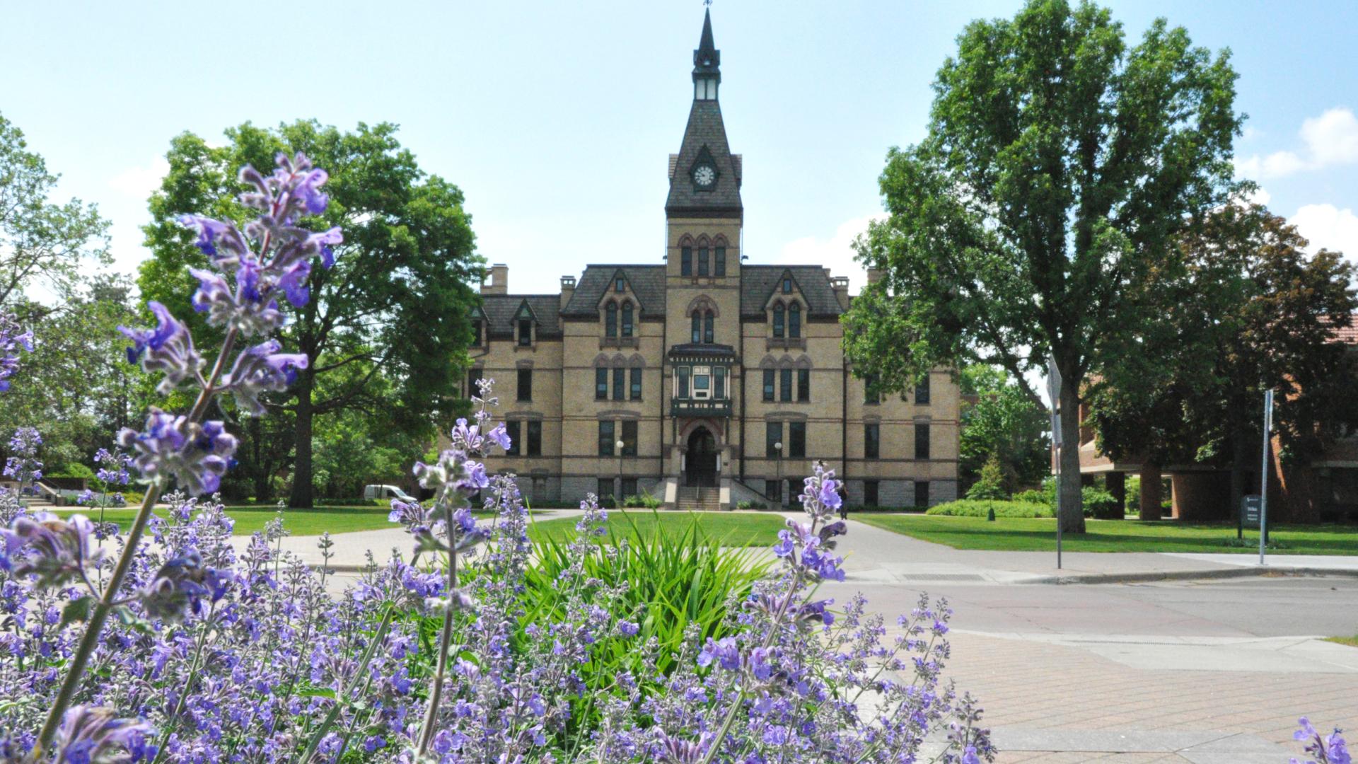 Old Main with purple flowers