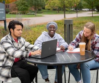 Three students studying outside