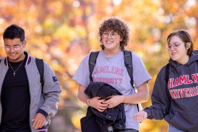 Three students walking on campus